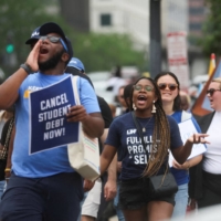 Supporters of U.S. President Joe Biden\'s s plans for student debt relief march near the White House after a U.S. Supreme Court decision blocking the president\'s plan to cancel $430 billion in student loan debt, in Washington, on June 30. | REUTERS