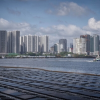A floating solar power plant in Singapore. Even with investments in solar forecast to surpass spending on oil production for the first time this year, many regions face challenges in finding land on which to install vast arrays of panels | BLOOMBERG