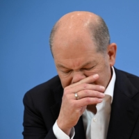 German Chancellor Olaf Scholz holds a news conference in Berlin on Friday.  | REUTERS 