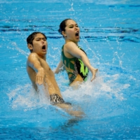 Japan\'s Tomoka Sato and Yotaro Sato perform during the mixed duet preliminaries as part of the artistic swimming program at the World Aquatics Championships in Fukuoka on Saturday.  | REUTERS