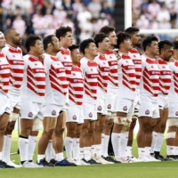 Japan\'s players stand for the national anthem ahead of an international friendly against an All Blacks XV in Kumamoto on Saturday. | KYODO