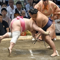 Hoshoryu (right) defeats Ura during Day 8 of the Nagoya Grand Sumo tournament at Dolphins Arena on Sunday. | KYODO