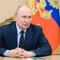 Russian President Vladimir Putin holds a meeting in Moscow on Friday. Putin has said Russia would use cluster bombs if they’re used against his troops, while denying that Kremlin forces have already used the controversial munitions in Ukraine. | SPUTNIK / VIA AFP-JIJI