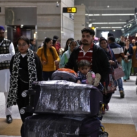 Travelers at the departure area of Indira Gandhi International Airport in New Delhi in December 2022 | REUTERS