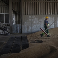 A Ukrainian worker cleans up after grain is unloaded at the Continental Farmers Group facility on the outskirts of Ternopil, Ukraine, in July 2022. Russia said on Monday that it was withdrawing from a wartime agreement to allow grain exports | DIEGO IBARRA SáNCHEZ / THE NEW YORK TIMES