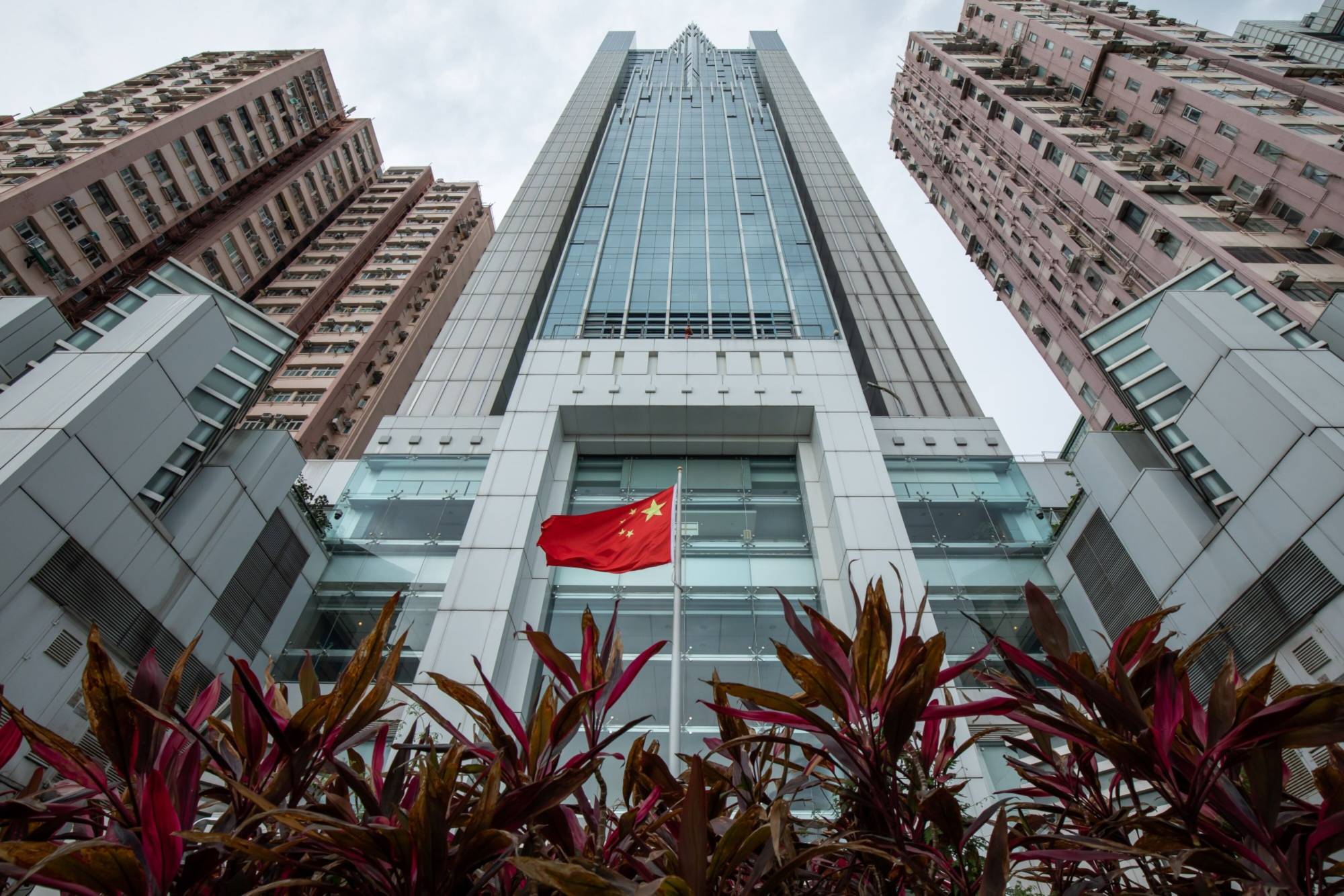 The Chinese flag flies in front of the Liaison Office of the Central People's Government in Hong Kong. Beijing has tapped a former top official from its secret intelligence agency to lead China's national security office in Hong Kong. | BLOOMBERG