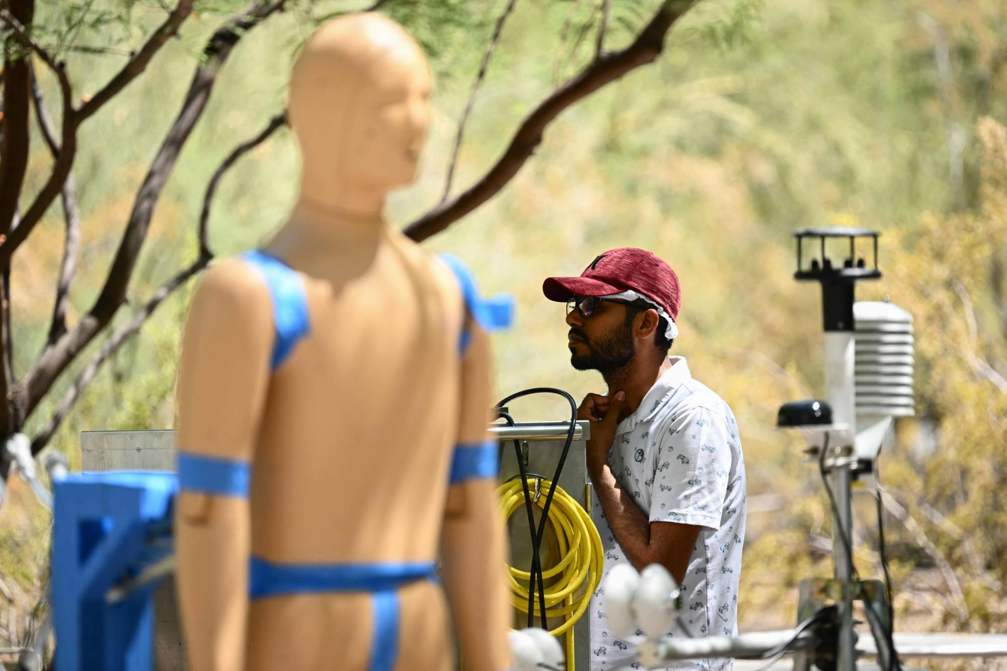 Ankit Joshi monitors a heat and wind experiment with ANDI, an Advanced Newton Dynamic Instrument, to learn more about the effect of heat exposure on the human body at Arizona State University on Thursday, during a record heat wave in Phoenix.  | AFP-JIJI