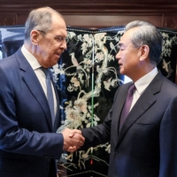 Russian Foreign Minister Sergey Lavrov and top Chinese diplomat Wang Yi prior to their talks in Jakarta on July 13. | RUSSIAN FOREIGN MINISTRY / VIA AFP-JIJI