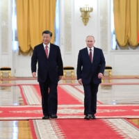 Chinese leader Xi Jinping and Russian President Vladimir Putin attend a welcome ceremony before talks at the Kremlin in Moscow in March.  | SPUTNIK / KREMLIN / VIA REUTERS