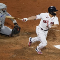 Masataka Yoshida gets his third hit of the night for the Red Sox against the Mets during Game 2 of their doubleheader in Boston on Saturday. | KYODO