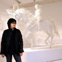 Powerful procession: Motohiko Odani cuts a rock-starlike figure in front of one of his recent sculptures, \"Hollow: What rushes through every mind,\" at his new solo exhibition at Tokyo\'s Mori Art Museum. | SATOKO KAWASAKI PHOTOS