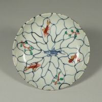 \"Porcelain Dish with Fish and Water Plants against an Overall Fishnet Design in Underglaze Blue and Overglaze Enamels\" (Ming Dynasty, 17th century) | GIFT OF MR. MIKIO HORIO