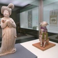 It\'s a dog\'s life: \"Chinese Court Lady Holding a Pekinese\" (Tang Dynasty, eighth century), and \"Dog-shaped Saga Doll\" (Edo Period, 17th century). | KYOTO NATIONAL MUSEUM/SACHIKO TAMASHIGE PHOTOS