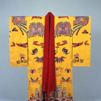 Royal threads: A designated national treasure bingata (Ryukyuan resist-dyed)costume decorated with Chinese phoenixes, bats and waves on a yellow background. (18th-19th century). | NAHA CITY MUSEUM OF HISTORY