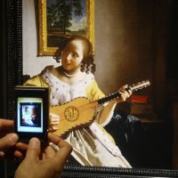 Snapshot: A visitor takes a photo of a replica of Johannes Vermeer\'s \"Guitar Player. | GIANNI SIMONE