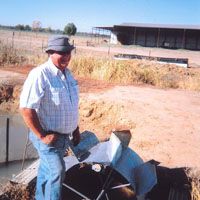 An outback farmer stands beside an early 20th-century Dethridge water-wheel | (C) KLEIN DYTHAM ARCHITECTURE