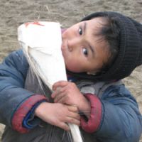 A boy chomps on a chunk of baleen from a grey whale. | PIA FILM FESTIVAL