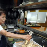 Wood you believe it?: A worker at the Shokudo Shogetsu restaurant in Tamachi, Tokyo, adds to the diner\'s daily tally of single use waribashi chopsticks. | YOSHIAKI MIURA PHOTO