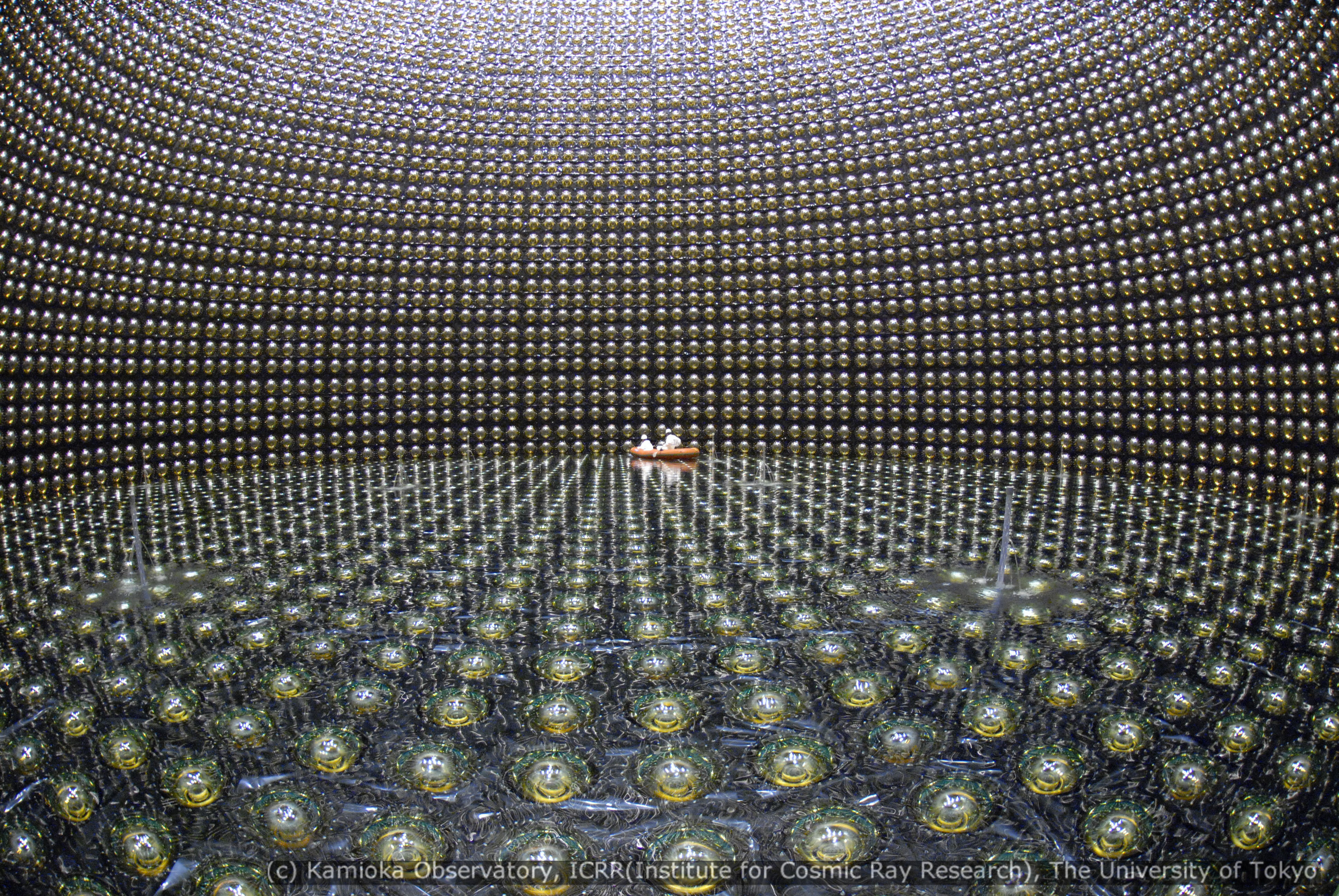 Lights fantastic: A kilometer under Mount Kamioka in Gifu Prefecture, workers in 2006 begin filling the Super-K detector. This vast stainless-steel tank holds 50,000 tons of ultra-pure water and has more than 10,000 photo-detectors to register neutrinos beamed from the J-PARC particle accelerator at Tokai, Ibaraki Prefecture. | &#169;KAMIOKA OBSERVATORY, ICRR (INSTITUTE FOR COSMIC RAY RESEARCH), THE UNIVERSITY OF TOKYO