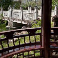 All-round good: This circular pavilion tucked into one corner of the garden provides a perfect resting place, with a soothing view of rockeries, a bridge and water. | STEPHEN MANSFIELD PHOTOS