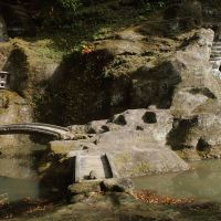 Raw beauty: With only minor adjustments, the rocky bluff at the rear of Zuisen-ji Temple has been co-opted as a dry-landscape garden &#8212; though one which controversially boasts a small spring-fed pond crossed by a miniature bridge leading to a cave. | STEPHEN MANSFIELD