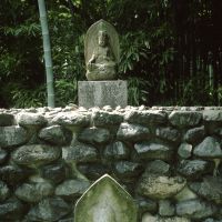 Adding to the site\'s divinity, the pathway that circles the garden is full of ancient Buddhist statuary like this. | C.W. NICOL