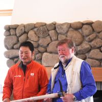 Horse-logger Takashi Iwama  presents Old Nic with a logging tool embossed with \"Aka Oni,\" meaning \"Red Devil,\" on the handle. | HILLEL WRIGHT PHOTOS