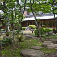 Green serene: Big steppingstones and an assertive nigatsudo (pedestal) type of stone lantern are typical of gardens of privilege from the turn of the 19th century, such as that at the Kyu Asakura Residence in Tokyo, where azaleas and ferns are used to soften the effect of hard stone (below left) and fusuma (paper doors) in the house are painted to complement the exterior. | STEPHEN MANSFIELD PHOTOS