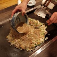 Native nosh: Monja Mugi in Tokyo\'s Tsukishima district serves monja-yaki, a flour-and-water-based dish with meat and vegetable toppings that is cooked on a griddle at your table; it is one of around 70 restaurants serving the dish on Monja Street. | KOHJI SHIIKI