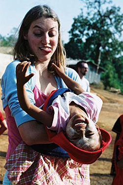 Go-Mad volunteer Sarah Ryder upends a student at the Baan Unrak school in Thailand (top), while (below top) a JET teacher leads students in song at Panskura School in India and (bottom) a student at Baan Unrak makes a Christmas card. JET set Go MAD globally to help children in need
