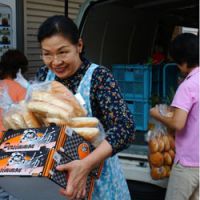 Helping hands: A worker for the House of Hope hospice in Tokyo\'s Sanya area picks up supplies from a Second Harvest delivery. | CARIN SMOLINSKI