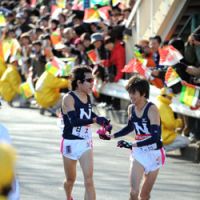 Go for it: A Nihon University runner hands the team\'s iconic  tasuki  sash to the next runner (right) at the end of his stage in the 2008 Hakone Ekiden. | NIHON UNIVERSITY