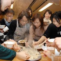 Yum: Chinese students teach Japanese how to make Chinese-style dumplings at an event at the Tokyo International Exchange Center in Tokyo last month. | YOSHIAKI MIURA PHOTO