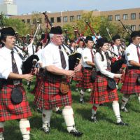 Strains of home: Bagpipers, including piping judge Iain MacDonald (second from left), march in the opening parade. | SATOKO KAWASAKI PHOTOS