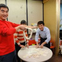 Taste of home: Chinese trainees make gyoza (Chinese-style meat dumplings) during a recent party at the shelter in Tokyo run by the Advocacy Network for Foreign Trainees. | COURTESY OF THE ADVOCACY NETWORK FOR FOREIGN TRAINEES