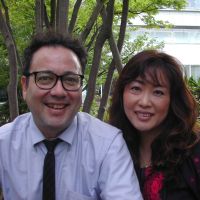 Two of a kind: Mike and Yuka Rogers pose outside a cafe in Setagaya Ward, Tokyo. | MAMI MARUKO PHOTO
