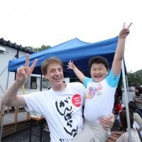 Distributing good vibes: Vincent Marx, a member of the Ganbaranba volunteer group, gives a \"free hug\" to a boy in Ofunato, Iwate Prefecture, during an event in September to cheer up tsunami survivors. | COURTESY OF TAKAYUKI SATO