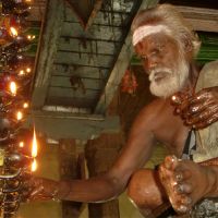 A lamplighter in the Meenakshi Temple at Madurai. | COURTESY OF PHRED KAUFMAN
