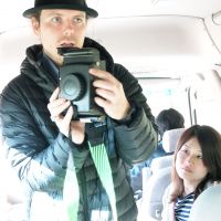 Brian Peterson explains the workings of a camera while Photohoku cofounder Yuko Yoshikawa looks on. | COURTESY OF JUSTYN BROWN