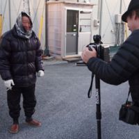 A Shinchi resident poses for Peterson\'s \"magic camera.\" | COURTESY OF JUSTYN BROWN