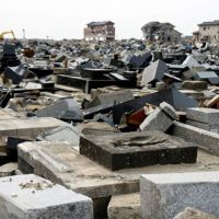 Rest disturbed: A cemetery lies wrecked in Yuriage, Natori city, Miyagi Prefecture, about 5 km from the ocean, nearly a month after the 3/11 tsunami. | JACK STONE