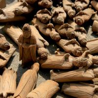 Still standing: Figurines found scattered for miles around the site of a temple in Yuriage, Natori city, Miyagi Prefecture, lie at the spot where the building once stood, in April 2011. People brought back many of the wooden pieces during the post-tsunami cleanup. | JACK STONE