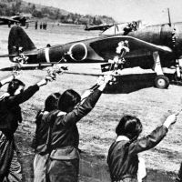 Fatal flowers: High school girls in Chiran, Kagoshima Prefecture, wave sprigs of cherry blossom for Second Lt. Toshio Anazawa as he sets off on April 12, 1945, on one of the  kamikaze suicide missions carried out by so-called Oka (Cherry-blossom) pilots like him. | SIMON SCOTT