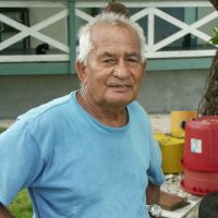 Where 79-year-old Joe de Brum runs a guesthouse. Meanwhile, with a storm brewing, fishermen sail off from Majuro in an outrigger. | CHRISTOPHER JOHNSON