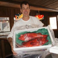 Catch of the day: James Gallagher poses with a box of menuke rockfish at his Ezo Seafood restaurant in the Niseko area of Hokkaido in February. | COURTESY OF JAMES GALLAGHER