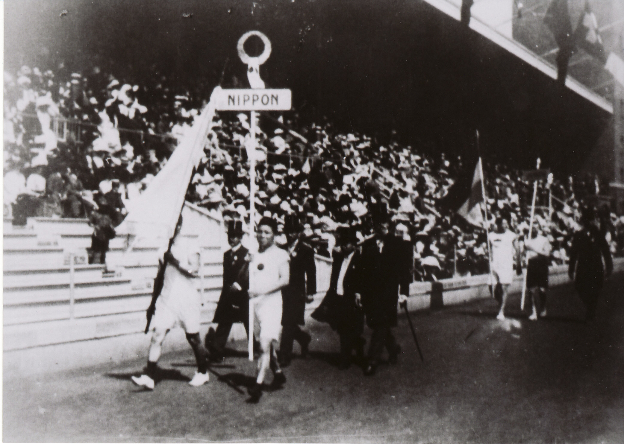 Glory days: Japan's first Olympians, Shiso Kanakuri (right) and Yahiko Mishima (holding flag), at the opening ceremony for the Stockholm Games in 1912. | CLIVE FRANCE PHOTOS