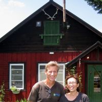 Diversified: Stefan Koester-Hirose poses with his wife, Kayoko, in front of their cafe in Biei, Hokkaido. | KRIS KOSAKA