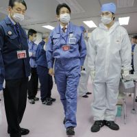 Going nuclear again?: Prime Minister Shinzo Abe (center) inspects Tokyo Electric Power Co.\'s emergency operation center at the crippled Fukushima No. 1 nuclear power plant in Okuma, Fukushima Prefecture, on Dec. 29. His ruling Liberal Democratic Party has pledged to review the previous Democratic Party of Japan government\'s plans to phase out nuclear power. | AP