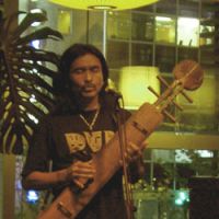Oki plays a five-string version of the tonkori at a Tokyo live show. | DANIEL ROBSON PHOTO
