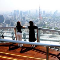 Visitors take in the sights from the newly opened Sky Deck atop the 52-story Roppongi Hills Mori Tower in Tokyo. | SATOKO KAWASAKI PHOTO